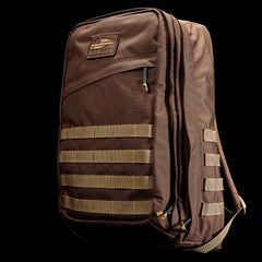 GORUCK brown tactical backpack with MOLLE webbing on black background