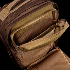 GORUCK brown tactical backpack showing open organized mesh pockets and rugged zippers