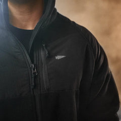 GORUCK black Dagger Jacket close-up with arrowhead logo and zipper detail
