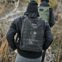 Person rucking outdoors with rugged GORUCK black backpack and outdoor gear