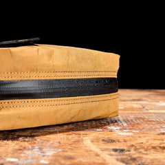 GORUCK coyote brown XPac bag detail with water-resistant zipper on wooden surface
