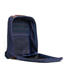 Open GR1 USA - Heritage Waxed Canvas backpack in navy blue stands upright, revealing organized compartments and an inner mesh pocket.