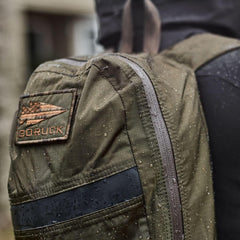 GORUCK waterproof backpack with logo patch and rain droplets outdoors
