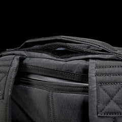 GORUCK black ruck backpack top handle and zipper detail against black background