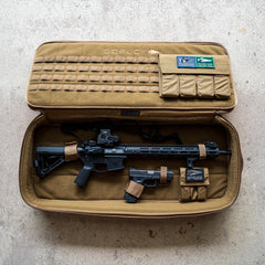 A Rifle Case in tan holds a rifle and a handgun securely, featuring organized compartments for storage.
