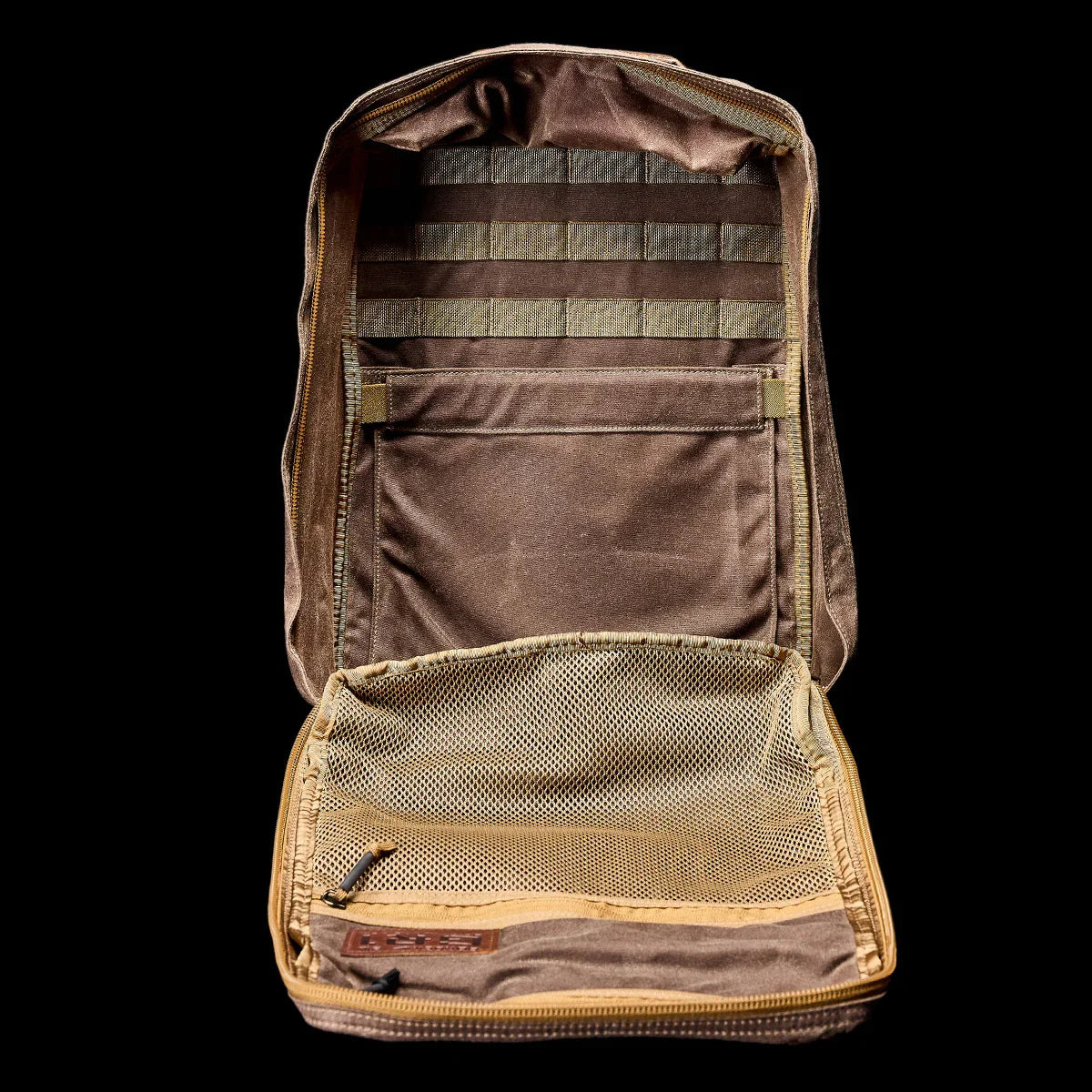 GORUCK dark oak GR1 backpack open, showing internal mesh pocket and MOLLE webbing