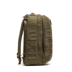 Side view of the olive green GR2 - Cordura backpack featuring multiple straps and a zippered compartment, perfect as a carry-on travel bag, shown on a white background.