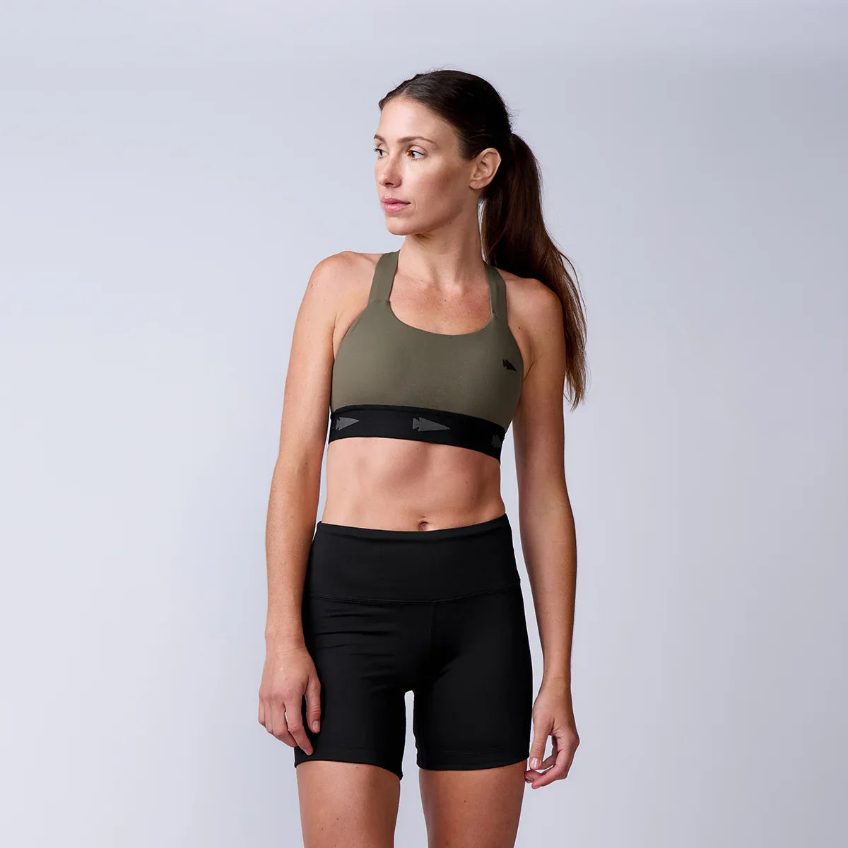 GORUCK women's rucking gear, athletic olive sports bra and black shorts, studio photo