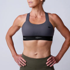 Woman wearing GORUCK sports bra and workout leggings, hands on hips, fitness apparel