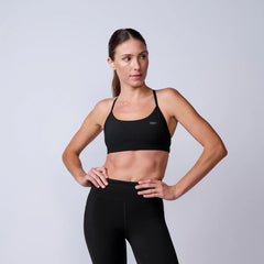 Woman wearing GORUCK black sports bra and leggings, athletic studio apparel