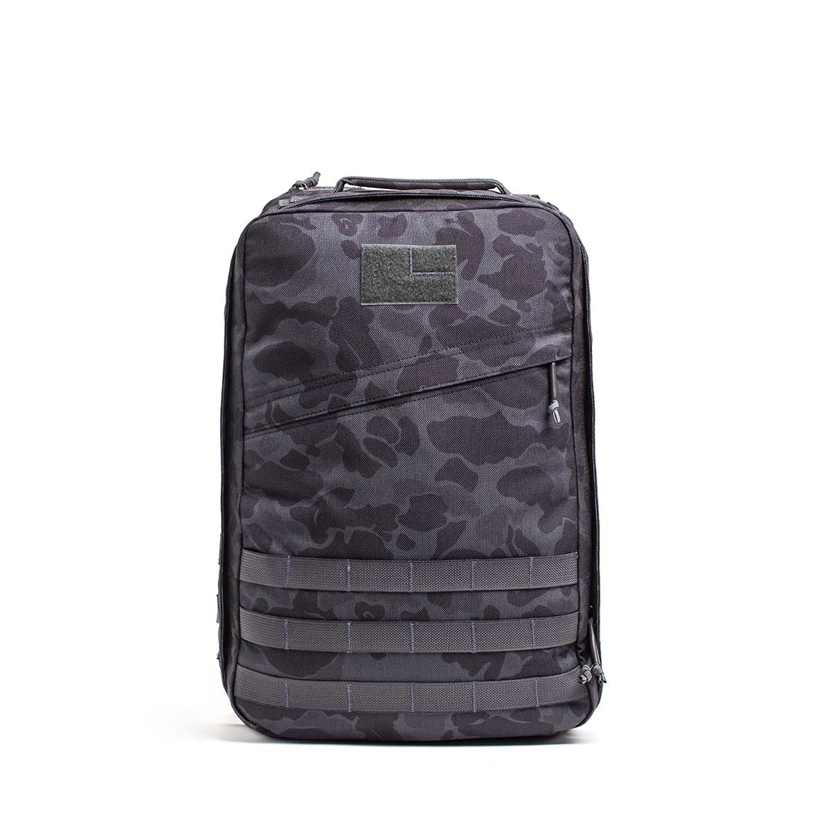 The GR1 rucksack in black and gray camouflage, featuring a front zipper and MOLLE webbing, is built to Special Forces grade standards and displayed upright on a white background.