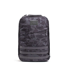 The GR1 rucksack features a black and gray camouflage pattern with a front zipper pocket, shown on a white background. Built to Special Forces grade, it's ideal for everyday carry.