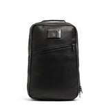 GORUCK black rucking backpack with angled zipper and top handle, front view on white background