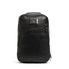 GORUCK black rucking backpack with angled zipper and top handle, front view on white background