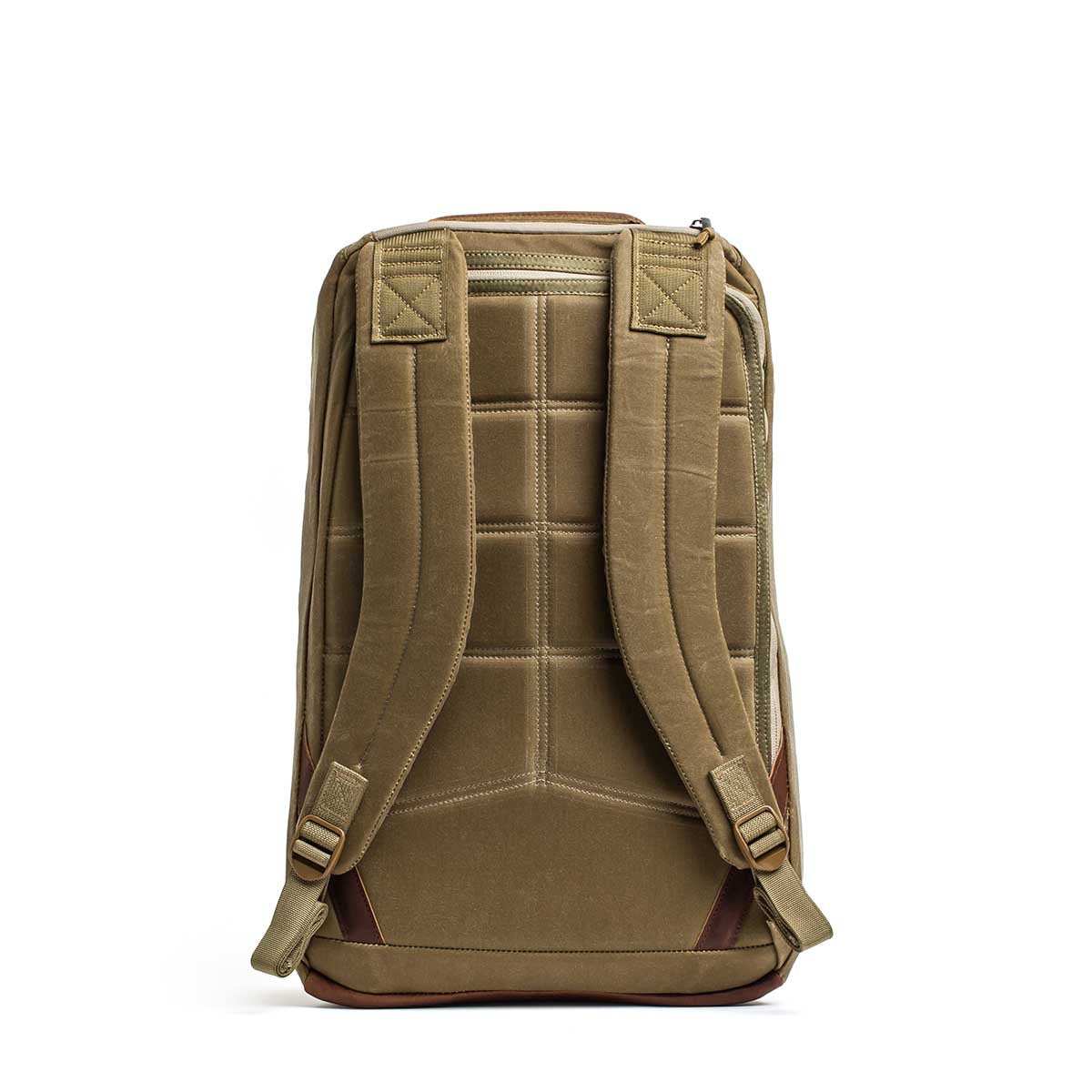 The GR1 USA - Heritage Waxed Canvas backpack in tan is shown from the back, highlighting its padded shoulder straps and quilted back panel.
