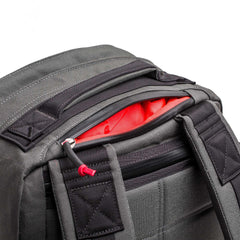 GORUCK 26L Armor Grey rucksack, close-up of durable black straps and open top zipper showing red liner.