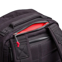 GORUCK black rucksack top section, showing durable 1000D fabric and red-lined pocket