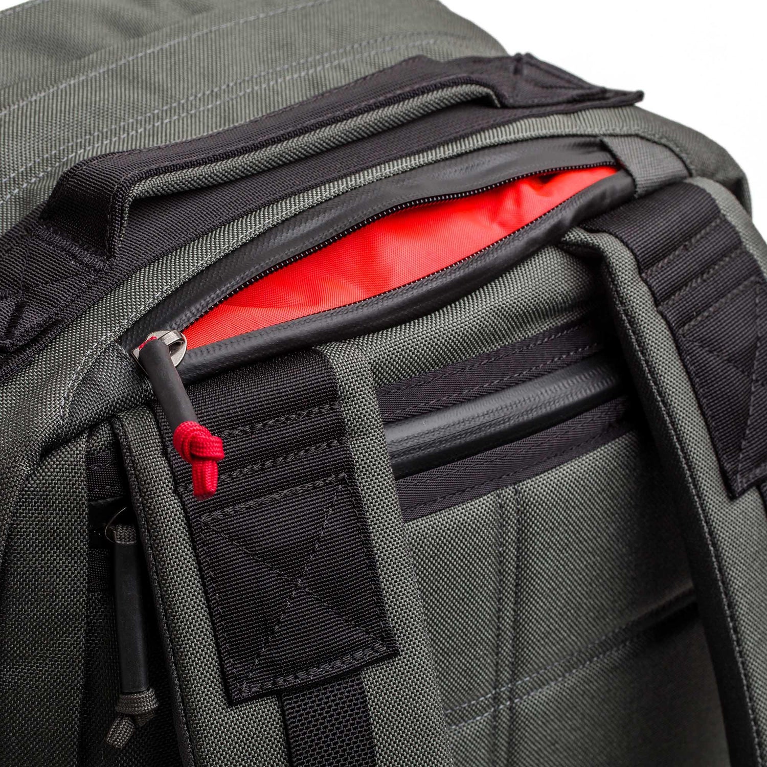 GORUCK grey and black tactical backpack with red interior and rugged shoulder straps