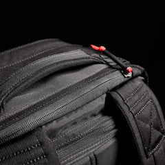 GORUCK black rucksack close-up showing durable fabric, sturdy zipper, and red zipper pulls