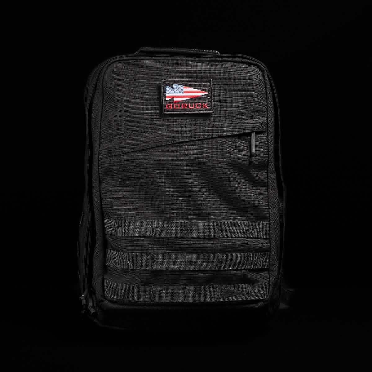 GORUCK black rucksack with American flag patch, rugged design against black background