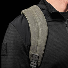 GORUCK Olive backpack strap on shoulder, rugged rucking gear close-up
