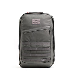 A gray GR2 - Cordura rucksack with a front zip pocket and horizontal webbing straps stands upright on a white background—perfect as a Special Forces backpack or carry-on travel bag.