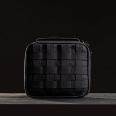 GORUCK black tactical field pouch with MOLLE webbing on a dark wood surface