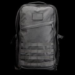 GORUCK black tactical rucksack with patch, durable nylon, and MOLLE webbing on black background.