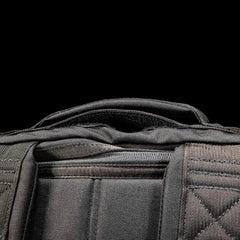 Close-up of GORUCK rucksack top handle and shoulder straps, durable black rucking gear