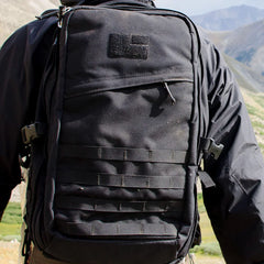 GORUCK black rucksack backpack worn outdoors, rugged gear for rucking and hiking