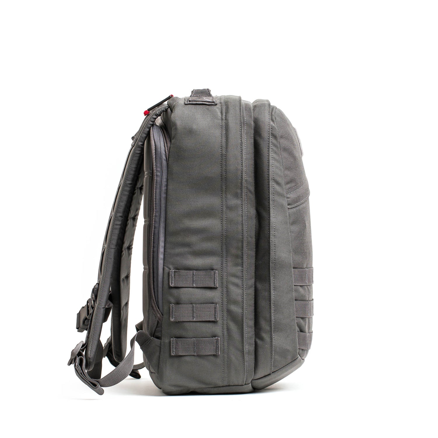 Side view of the gray GR2 - Cordura ruck travel backpack featuring multiple compartments and MOLLE webbing, displayed on a white background.