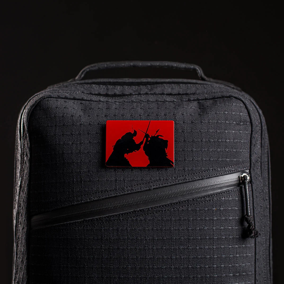 GORUCK black rucksack with red samurai patch, durable rucking gear close-up