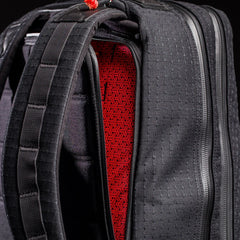 GORUCK black rucking backpack closeup showing red patterned interior and sturdy straps