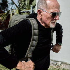 Man wearing GORUCK Ranger Green 40L rucksack outdoors, showcasing durable rucking gear