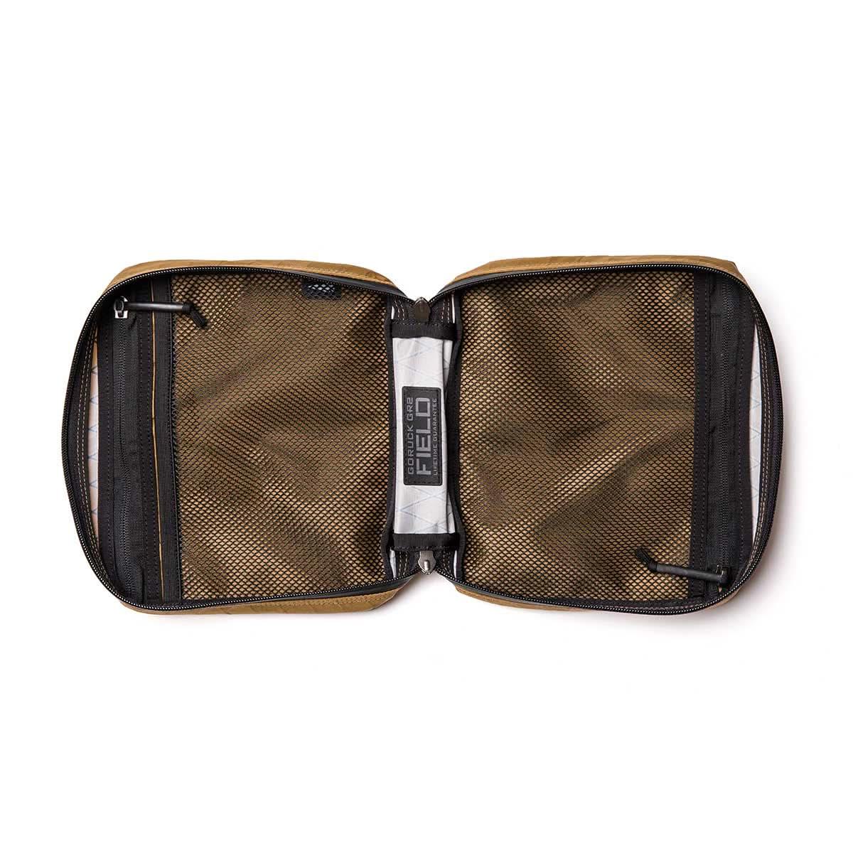 GORUCK brown XPAC Field Pouch open, showing mesh zip pockets and rugged interior.