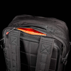 GORUCK black rucksack with padded straps and orange-lined zip pocket, durable rucking gear