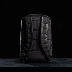 GORUCK black leather rucksack with padded straps and rugged design, back view on black