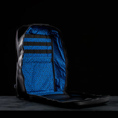 GORUCK black leather backpack open to show blue patterned interior and organization straps