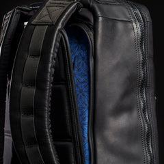 Close-up of GORUCK black leather backpack with padded straps and blue pattern lining
