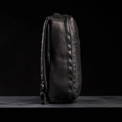 GORUCK black leather rucksack side view against black background, durable rucking gear