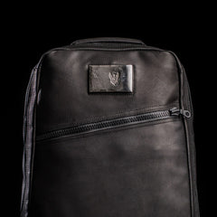 GORUCK black rucking backpack with angled zipper and patch on front, studio background