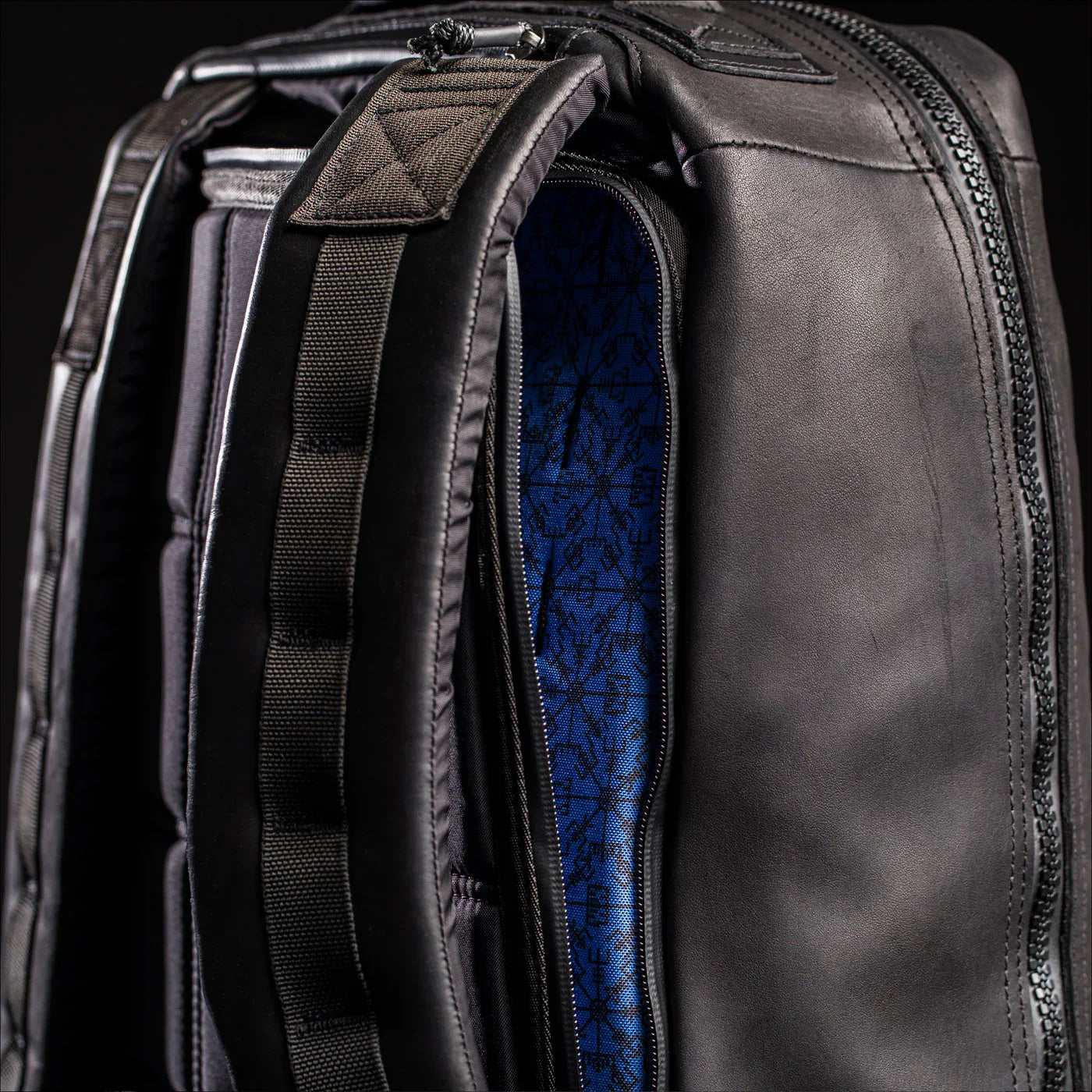 Close-up of GORUCK black rucksack with blue patterned interior and padded straps