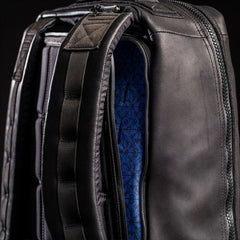 Close-up of GORUCK black rucksack with blue patterned interior and padded straps