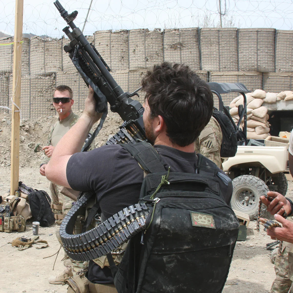 Man with GORUCK backpack, tactical gear, and ammunition in a military zone