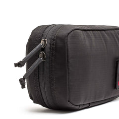 Close-up of a black IFAK pouch by GORUCK featuring two zipper pulls, shown against a white background.