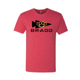 The BRAGG Event Tee - Tri-Blend is a premium red shirt with a black arrow and brass knuckles graphic above bold "BRAGG" lettering—ideal for your next event weekend.