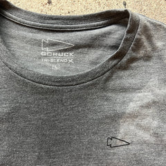 The Subtle Spearhead Tee - Unisex Tri-Blend is a gray t-shirt with a small arrow logo on the chest and inside the collar, inspired by Special Forces and featuring Anti-Stink technology.