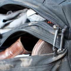 Close-up of an open black GR2 - Cordura carry-on travel bag, revealing brown shoes and clothes packed inside.