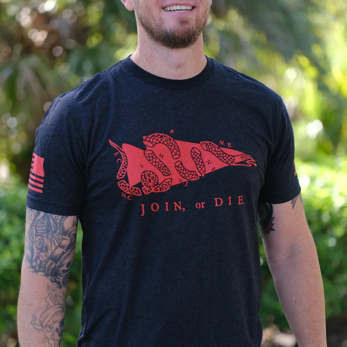 GORUCK t-shirt with red 'Join or Die' segmented snake graphic, outdoors, casual wear.
