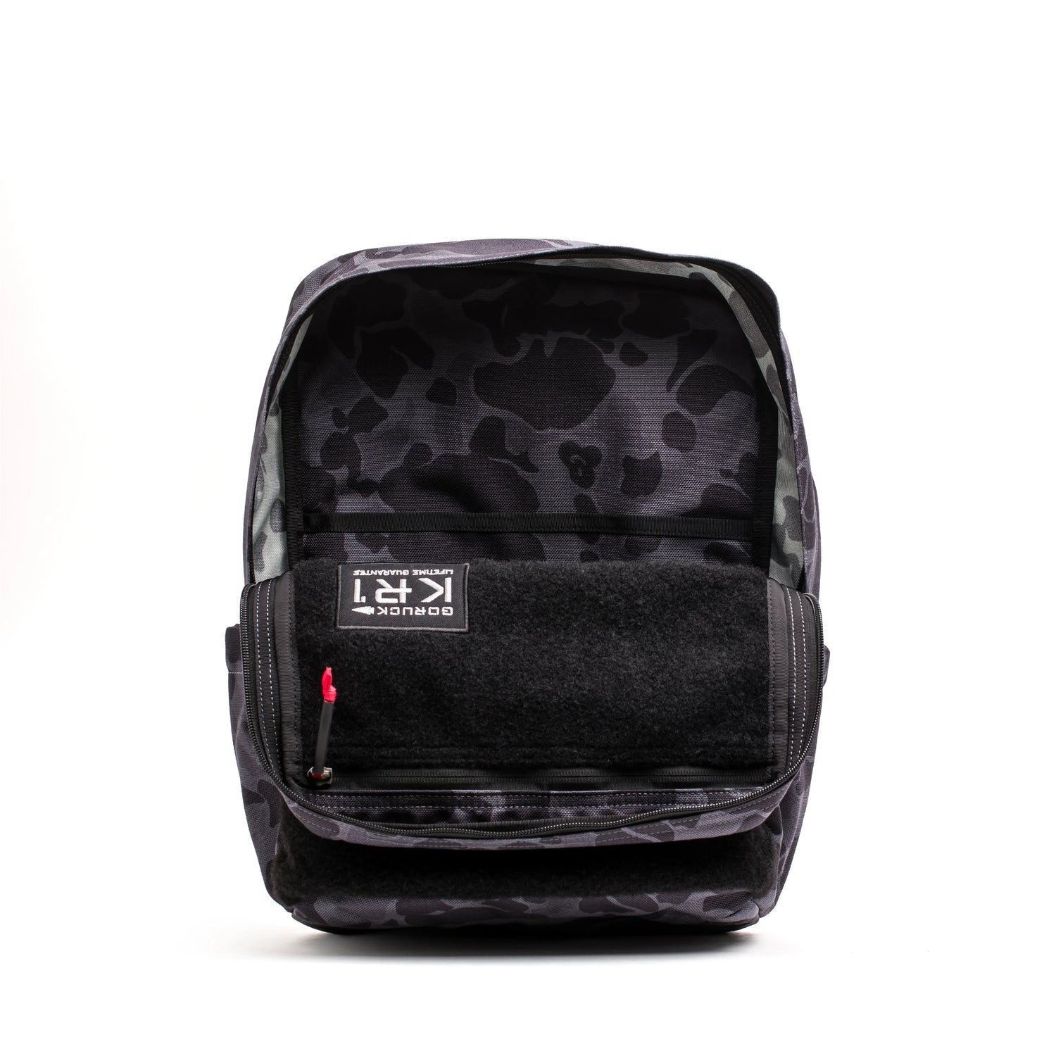GORUCK KR1 backpack in black camo pattern with open main compartment and visible interior label